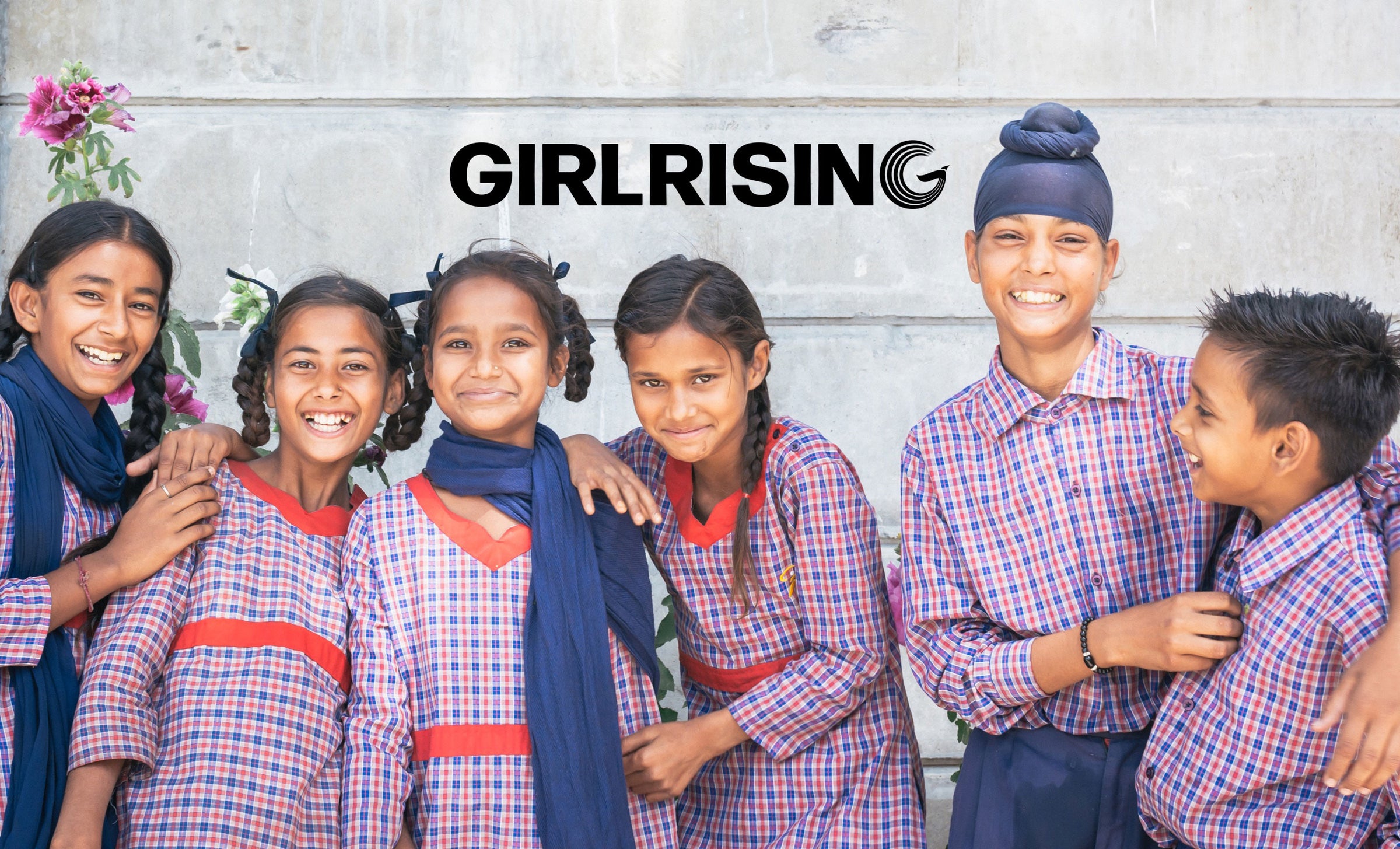 Image of Girl Rising members wearing their uniform with the Girl Rising logo at the top