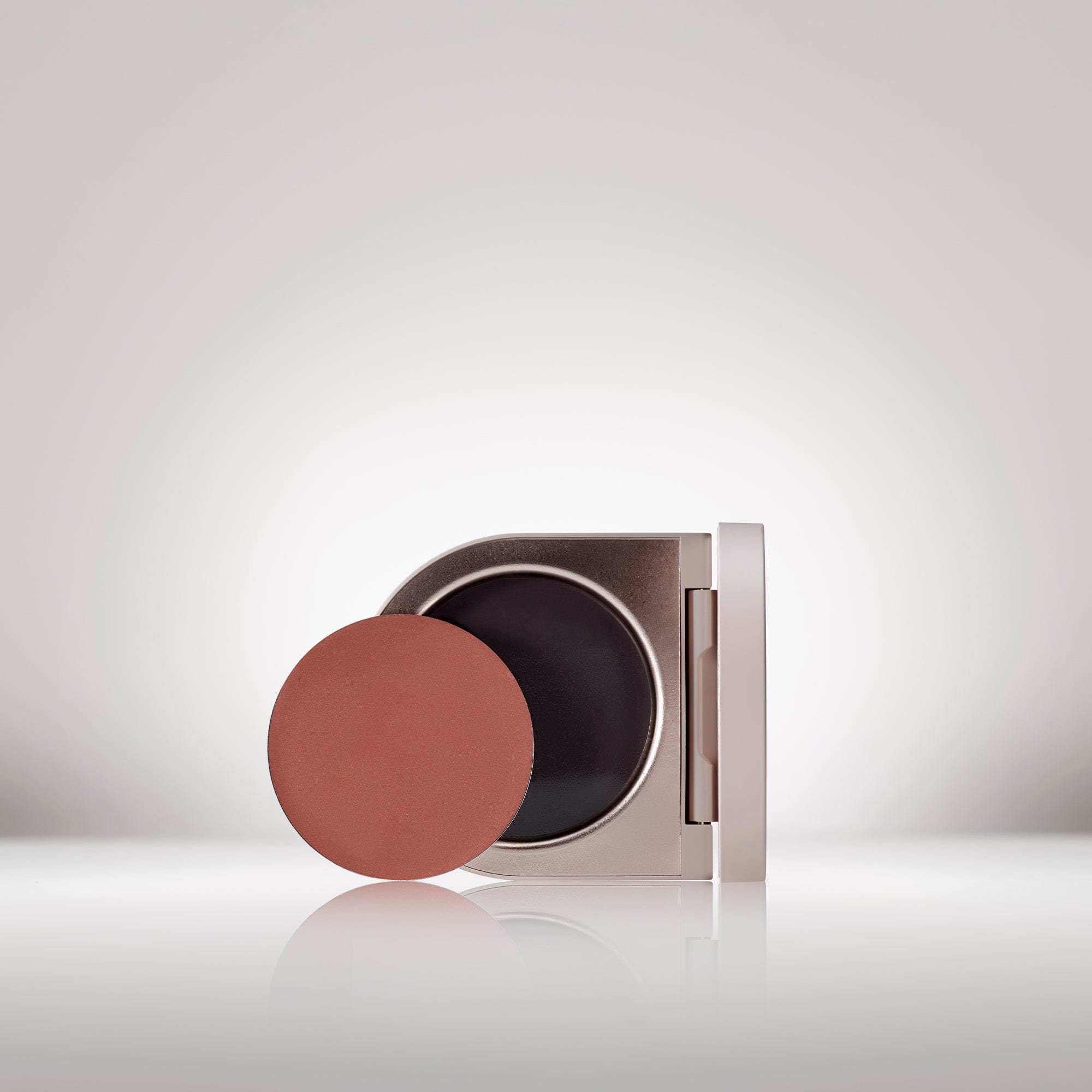 Image of the Cream Blush Refillable Cheek & Lip Color in Daylily in front of the open compact- Cream blush