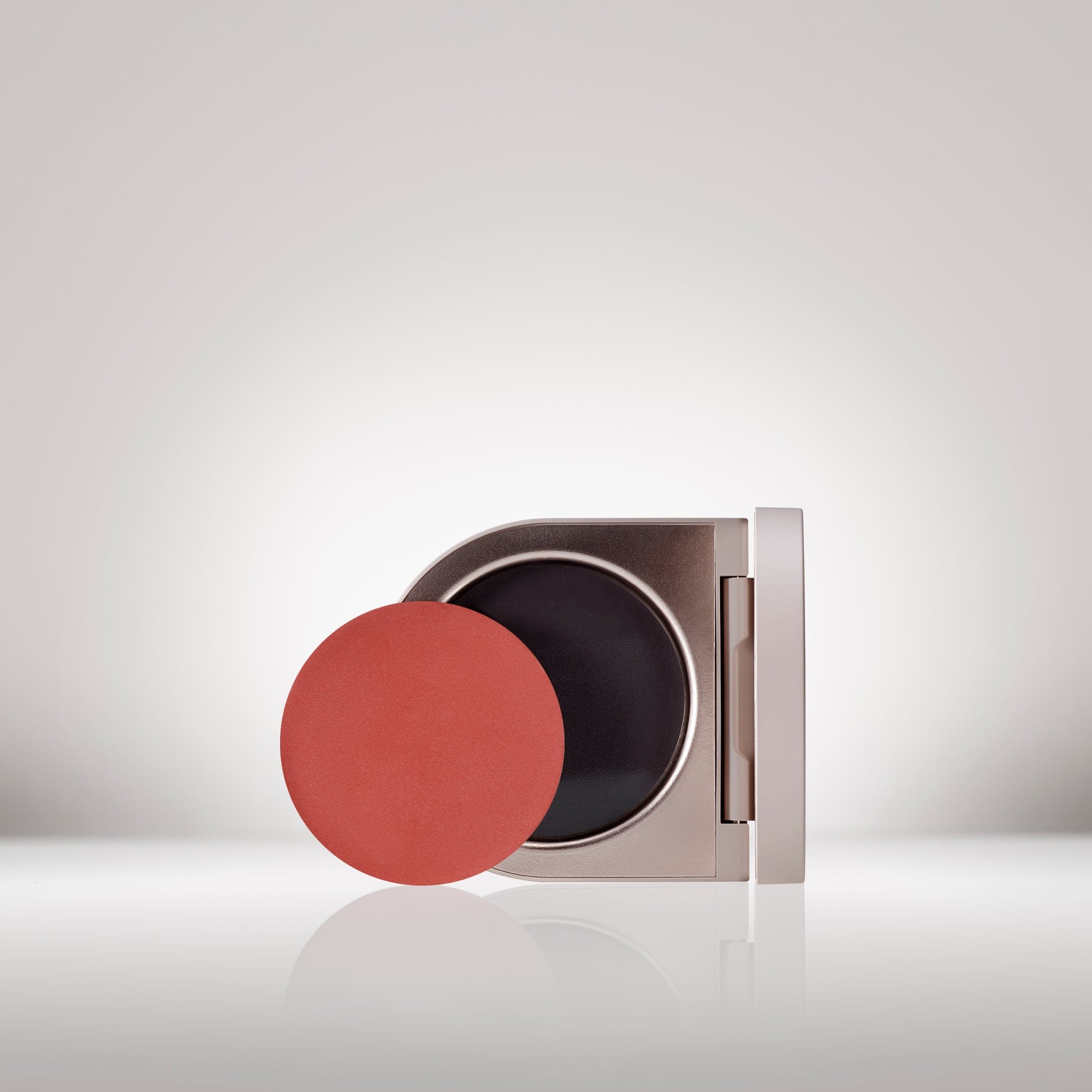 Image of the Cream Blush Refillable Cheek & Lip Color in Anemone in front of the open compact - Cream blush