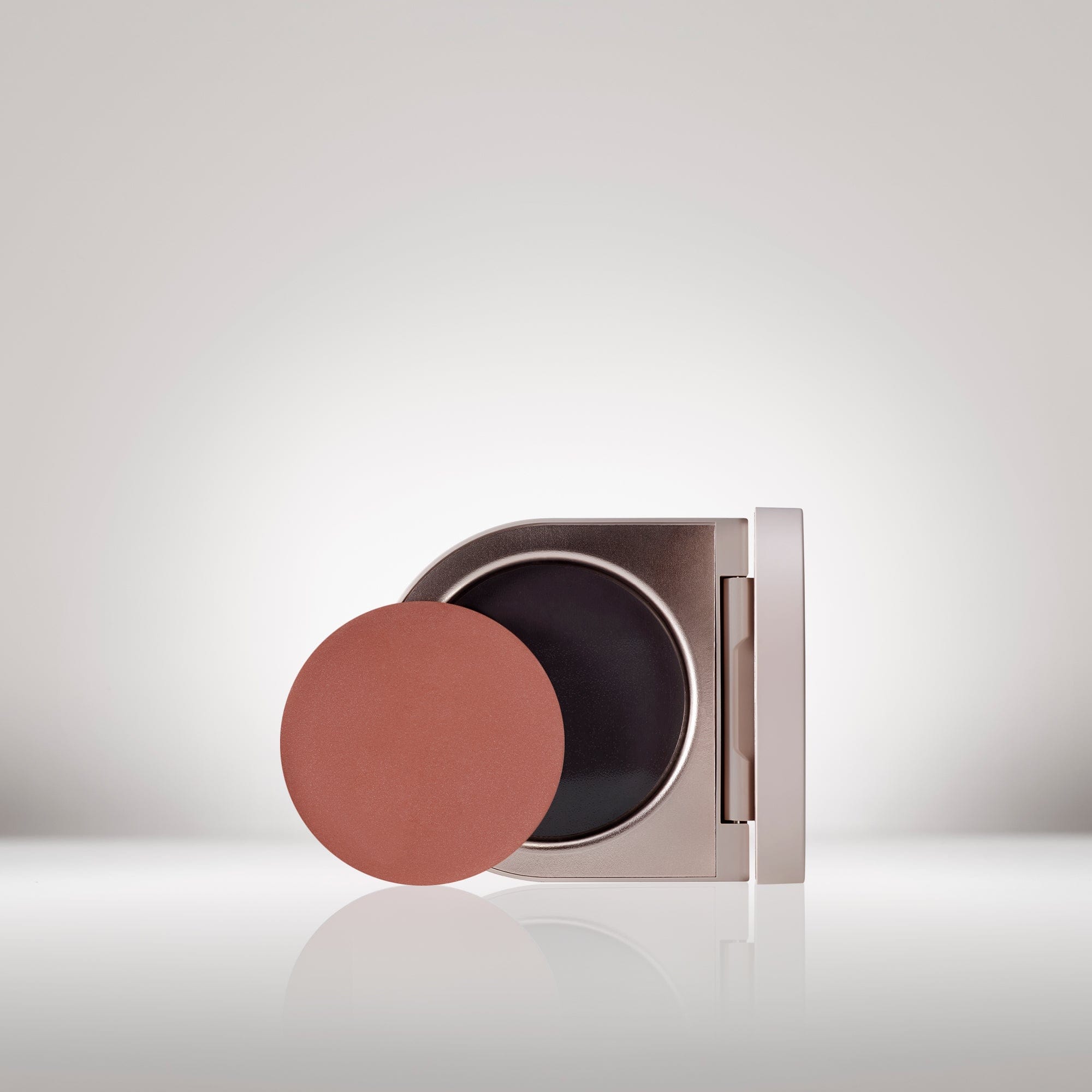 Image of the Cream Blush Refillable Cheek & Lip Color in Heliotrope in front of the open compact - Cream blush